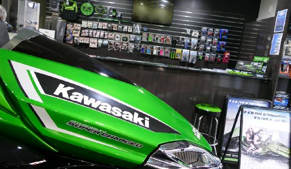 Jet Ski World store selling floor with green jet ski and assorted gear.